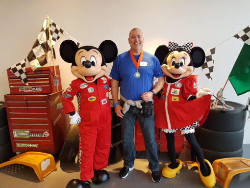 Mickey and Minnie Mouse in race car driver outfits